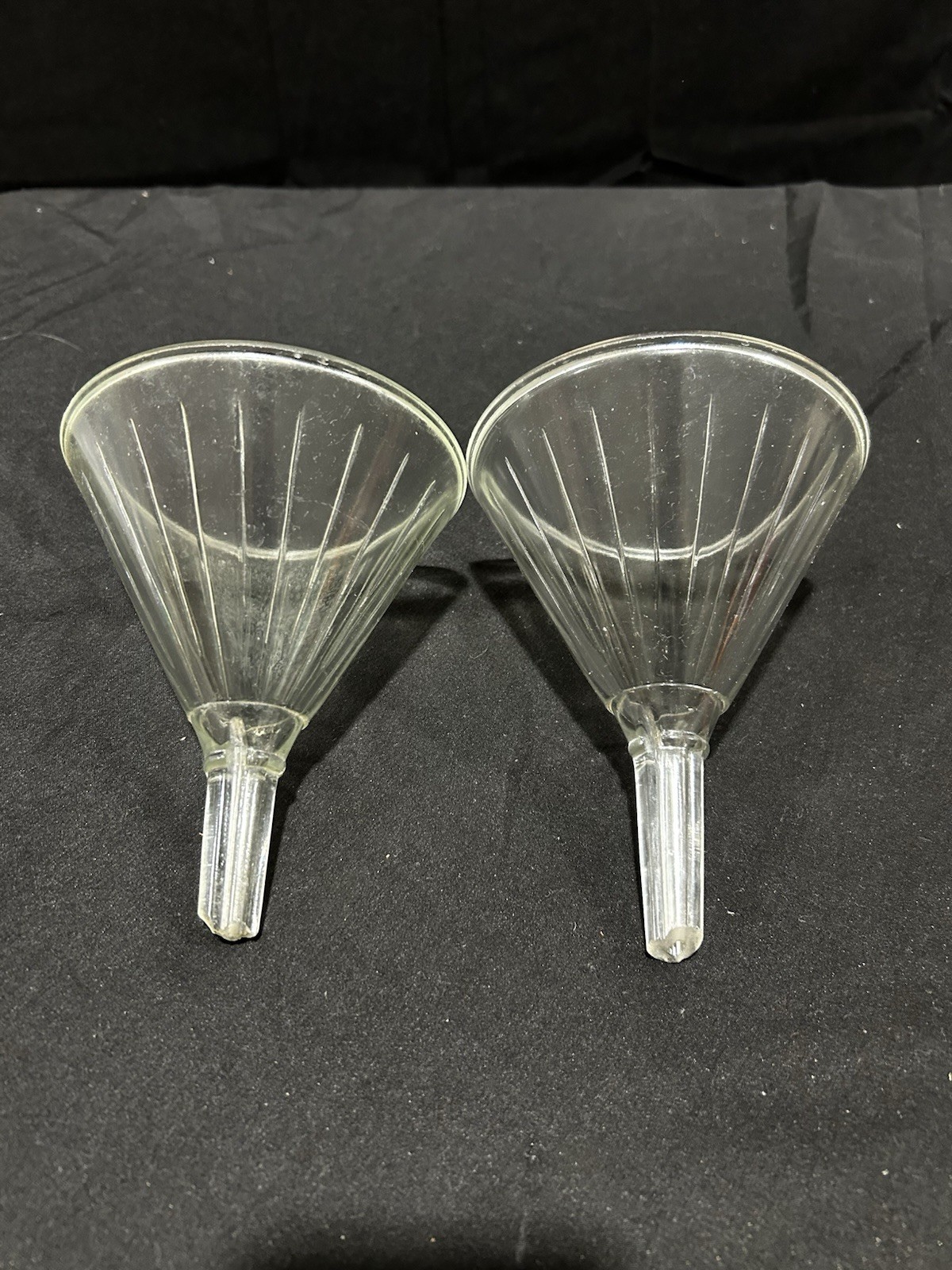 Two clear glass fluted funnel used for laboratory filtration